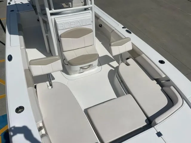 Slide: The Image of 2016 Robalo 246 Cayman boat interior with cushioned seating and storage. - 17