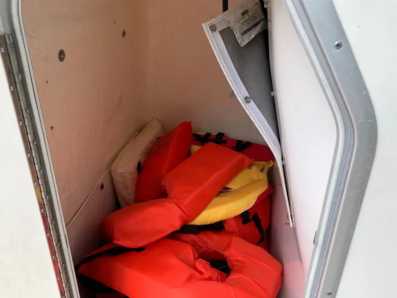 Slide: The Image of Storage compartment with life jackets on a 2013 NauticStar 210 Coastal boat. - 10