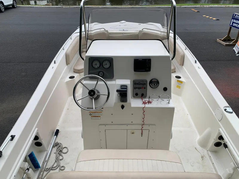 Slide: The Image of 2013 NauticStar 210 Coastal boat interior with steering console and seating. - 4