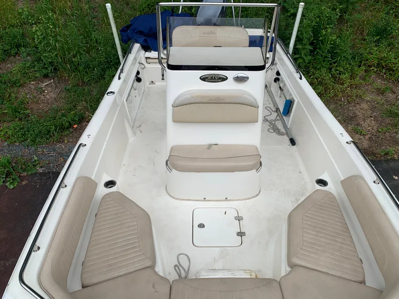 Slide: The Image of 2013 NauticStar 210 Coastal boat interior with seating and console. - 8