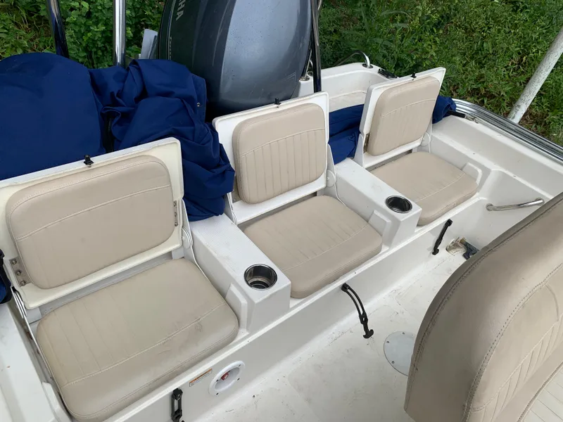 Slide: The Image of 2013 NauticStar 210 Coastal boat with beige seating and cup holders. - 9