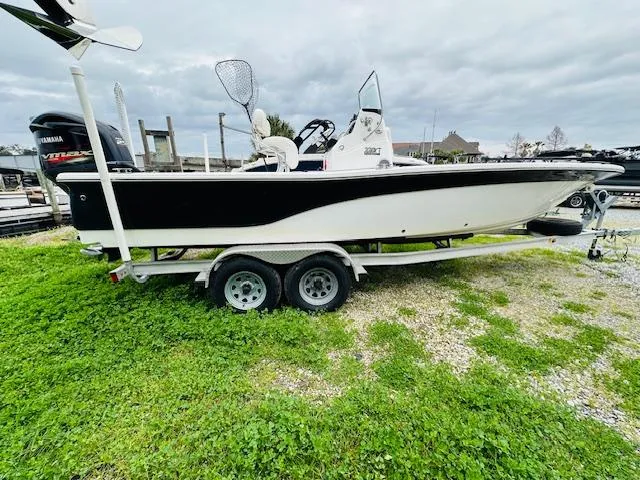 Slide: The Image of 2012 Sea Fox 22 XT boat on trailer, parked on grass, overcast sky. - 0