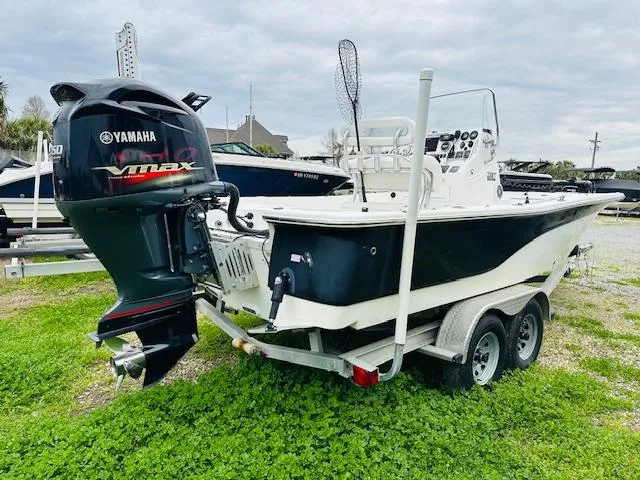 Slide: The Image of 2012 Sea Fox 22 XT boat with Yamaha VMAX engine on a trailer, parked on grass. - 1