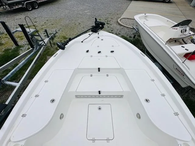 Slide: The Image of 2012 Sea Fox 22 XT boat deck, white, parked on gravel with trailer nearby. - 14