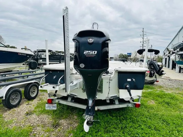 Slide: The Image of 2012 Sea Fox 22 XT boat with 250 horsepower engine, parked on grass near trailers. - 2