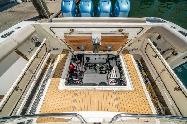 Slide: The Image of 2017 Boston Whaler 42 OUTRAGE engine compartment with open hatch and four outboard motors. - 10
