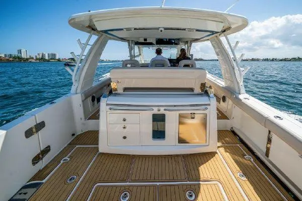 Slide: The Image of 2017 Boston Whaler 42 OUTRAGE boat interior with seating and storage, cruising on water. - 14