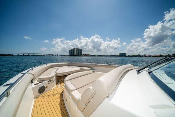 Slide: The Image of 2017 Boston Whaler 42 OUTRAGE boat on water with city skyline in background. - 21