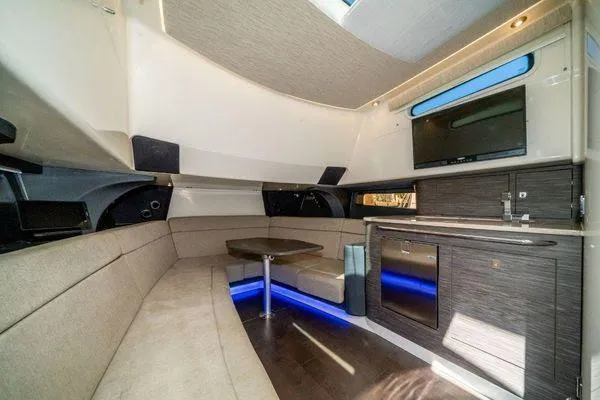 Slide: The Image of Luxurious interior of 2017 Boston Whaler 42 OUTRAGE with seating, kitchenette, and TV. - 27