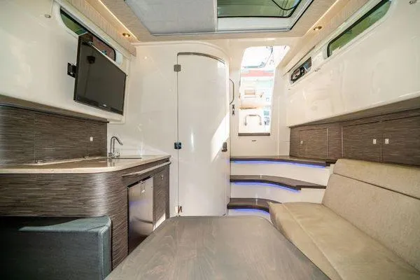 Slide: The Image of Interior of 2017 Boston Whaler 42 OUTRAGE with kitchenette, seating, and modern design. - 29