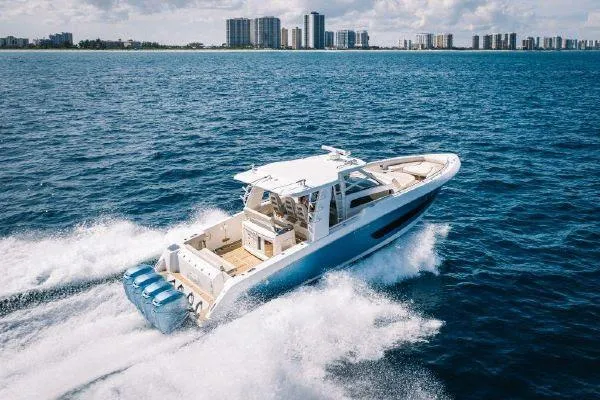 Slide: The Image of 2017 Boston Whaler 42 OUTRAGE cruising on open water near city skyline. - 3