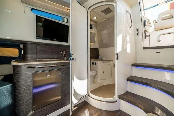 Slide: The Image of Interior of 2017 Boston Whaler 42 OUTRAGE with kitchenette, bathroom, and stairs. - 30