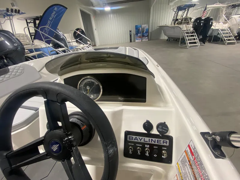 Slide: The Image of 2024 Bayliner Element M15 boat dashboard and steering wheel in showroom. - 11