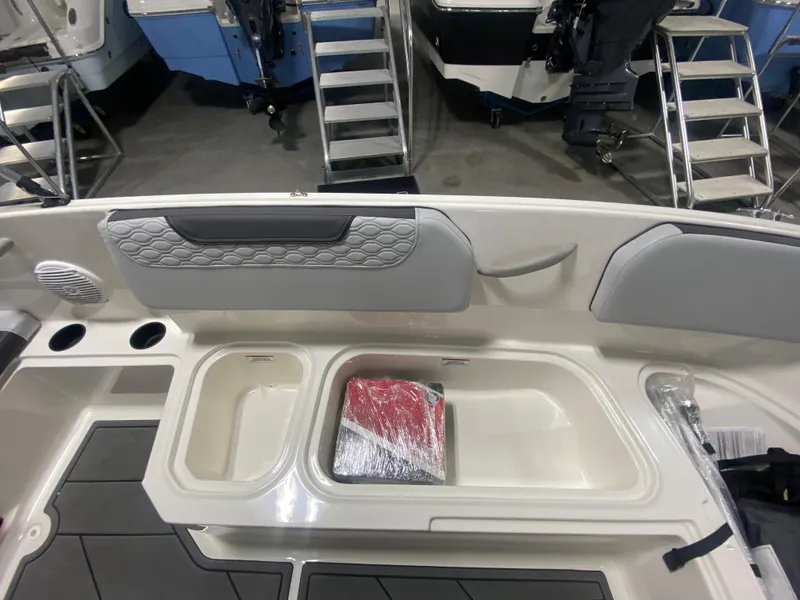 Slide: The Image of 2024 Bayliner Element M15 boat interior with storage compartments and seating. - 15
