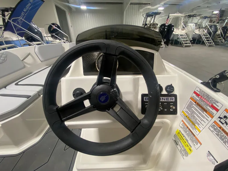 Slide: The Image of 2024 Bayliner Element M15 boat steering console in showroom. - 13