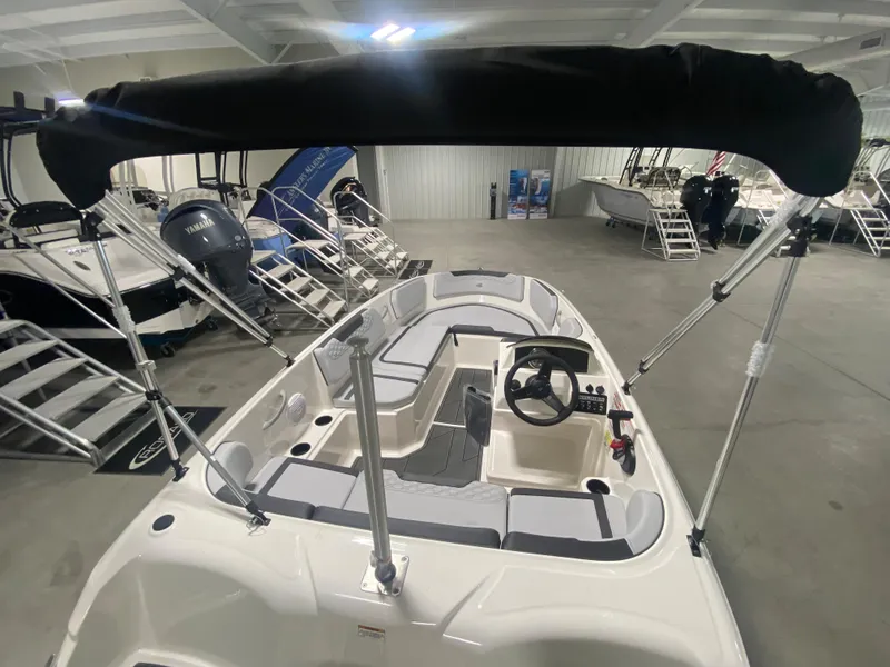 Slide: The Image of 2024 Bayliner Element M15 boat interior with seating and steering wheel. - 6