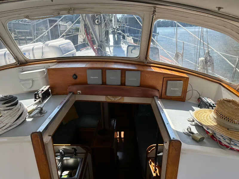 Slide: The Image of 1983 Brewer 42 Center Cockpit sailboat interior with navigation equipment and open hatch. - 13