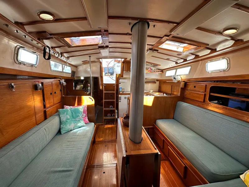 Slide: The Image of Interior of 1983 Brewer 42 Center Cockpit sailboat with wooden furnishings and cozy seating. - 25