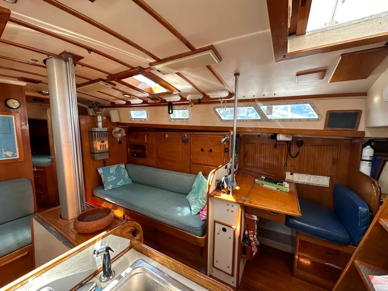 Slide: The Image of Cozy interior of 1983 Brewer 42 Center Cockpit sailboat with wood accents and seating area. - 26