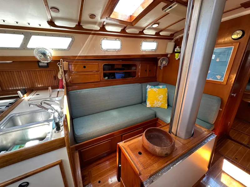 Slide: The Image of Interior of 1983 Brewer 42 Center Cockpit sailboat with cozy seating and kitchen area. - 27