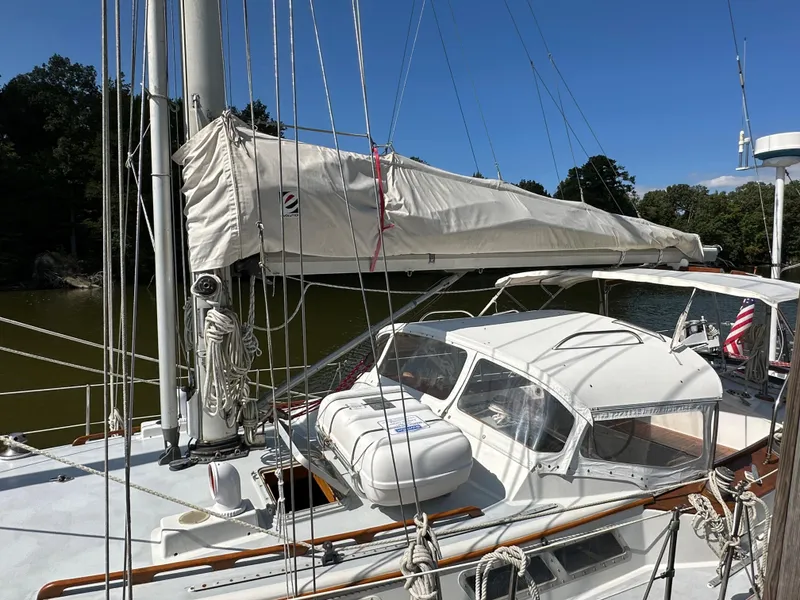 Slide: The Image of 1983 Brewer 42 Center Cockpit sailboat with covered sails, docked on a sunny day. - 7