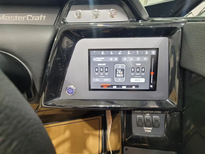 Slide: The Image of 2024 MasterCraft NXT22 dashboard with touchscreen controls and switches. - 14