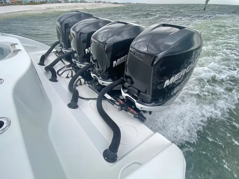 Slide: The Image of 2013 Yellowfin 39 boat with four Mercury outboard engines on the water. - 14