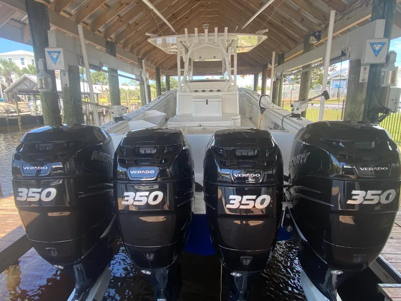 Slide: The Image of 2013 Yellowfin 39 boat with four Mercury Verado 350 outboard engines in a covered dock. - 15