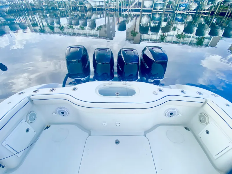 Slide: The Image of 2013 Yellowfin 39 boat with four outboard engines docked at marina. - 17
