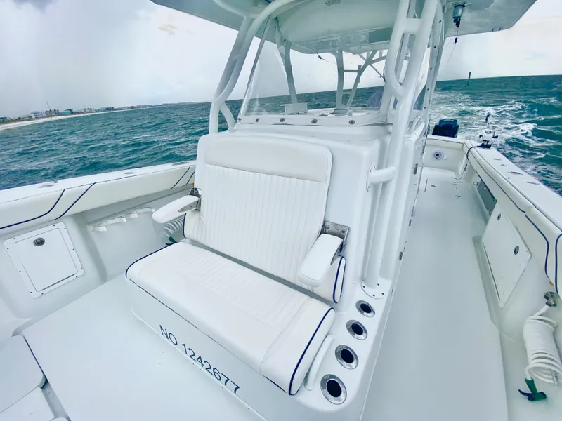 Slide: The Image of 2013 Yellowfin 39 boat with white seating and ocean backdrop. - 19