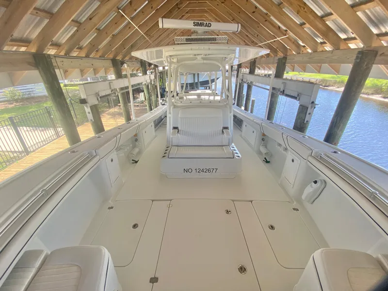 Slide: The Image of 2013 Yellowfin 39 boat under covered dock with spacious deck and Simrad electronics. - 25