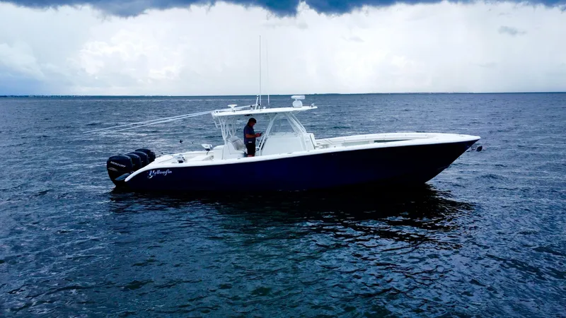 Slide: The Image of 2013 Yellowfin 39 boat on open water under cloudy sky. - 4