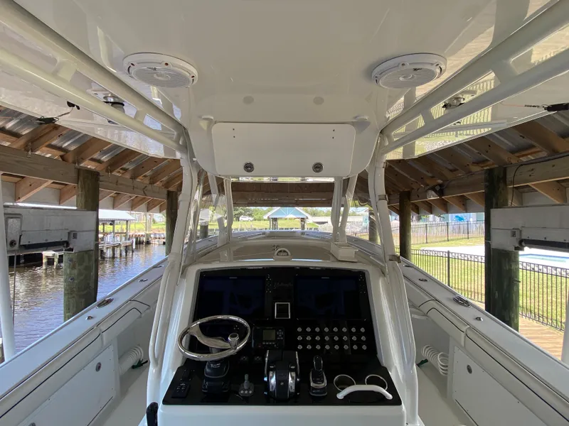 Slide: The Image of 2013 Yellowfin 39 boat cockpit with advanced navigation controls and steering wheel. - 40