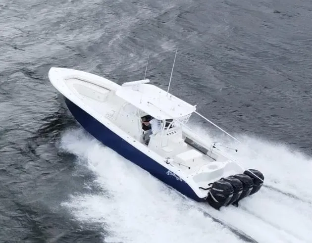 Slide: The Image of 2013 Yellowfin 39 boat cruising on water with triple outboard engines. - 5