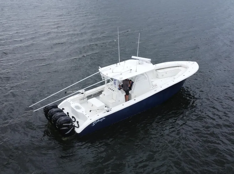Slide: The Image of 2013 Yellowfin 39 boat on water with triple outboard engines. - 6