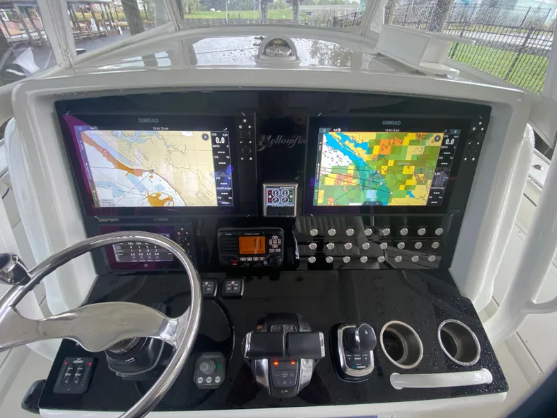 Slide: The Image of 2013 Yellowfin 39 boat dashboard with navigation screens and controls. - 8