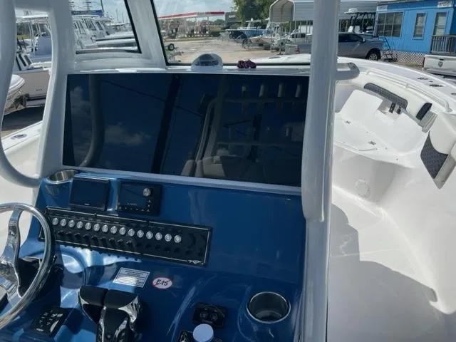 Slide: The Image of 2024 Tidewater 292 CC Adventure boat dashboard and controls. - 11