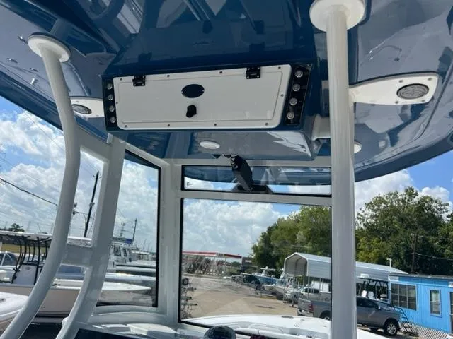 Slide: The Image of 2024 Tidewater 292 CC Adventure boat interior with blue hardtop and electronics. - 12