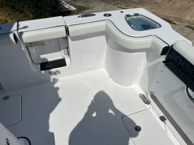 Slide: The Image of 2024 Tidewater 292 CC Adventure boat interior, featuring white seating and storage compartments. - 7