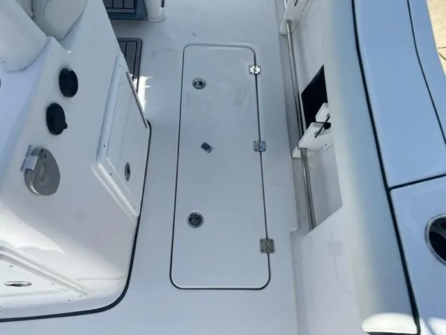 Slide: The Image of 2024 Tidewater 292 CC Adventure boat deck with storage compartment and control panel. - 9