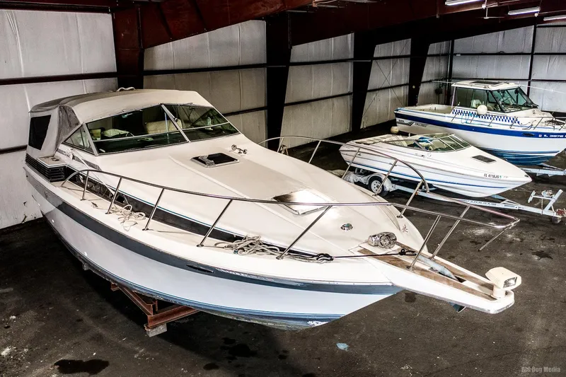 The Image of 1987 Chris-Craft 320 Amerosport Express boat in indoor storage. - 0