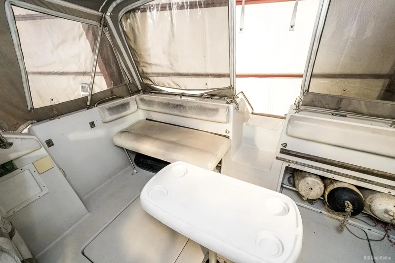 Slide: The Image of 1987 Chris-Craft 320 Amerosport Express boat interior with seating and table. - 1