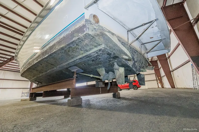 Slide: The Image of 1987 Chris-Craft 320 Amerosport Express boat hull in storage facility. - 11