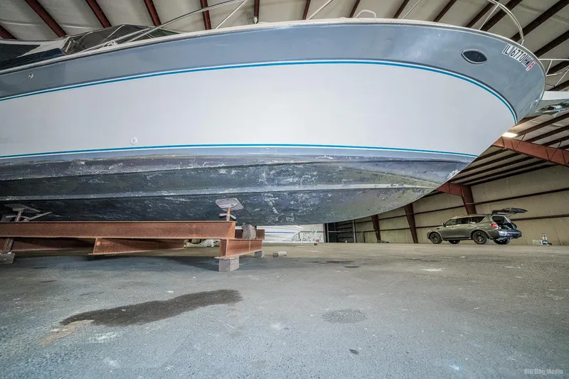 Slide: The Image of 1987 Chris-Craft 320 Amerosport Express boat in indoor storage facility. - 15