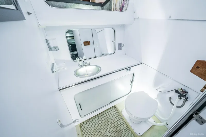 Slide: The Image of 1987 Chris-Craft 320 Amerosport Express boat bathroom with sink, mirror, and toilet. - 16