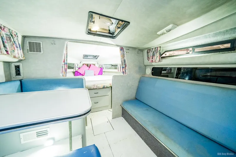 Slide: The Image of Interior of 1987 Chris-Craft 320 Amerosport Express with blue seating and dining area. - 18