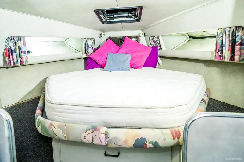 Slide: The Image of 1987 Chris-Craft 320 Amerosport Express cabin with bed and colorful pillows. - 20