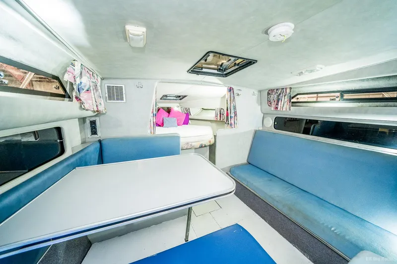 Slide: The Image of Interior of 1987 Chris-Craft 320 Amerosport Express with blue seating and dining area. - 21