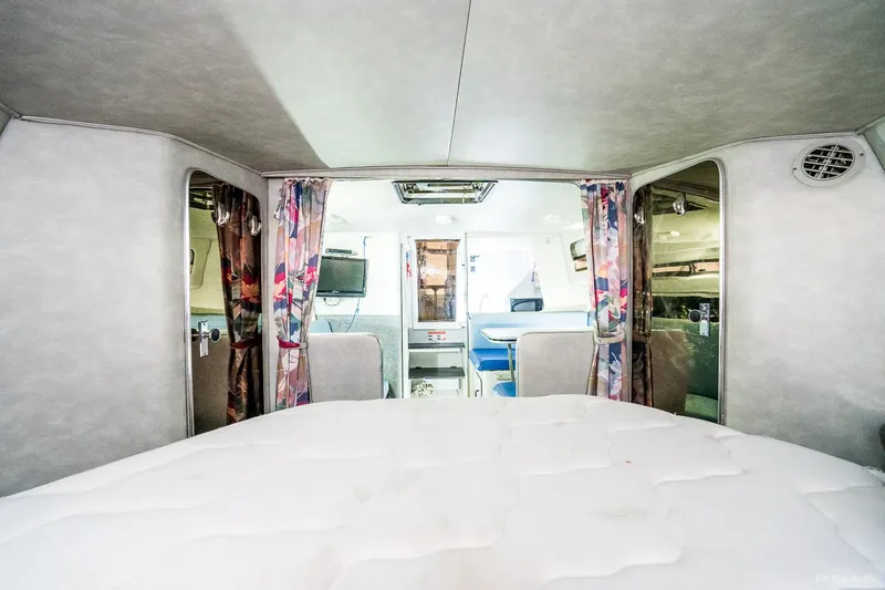 Slide: The Image of Interior cabin of 1987 Chris-Craft 320 Amerosport Express boat with bed and seating area. - 22