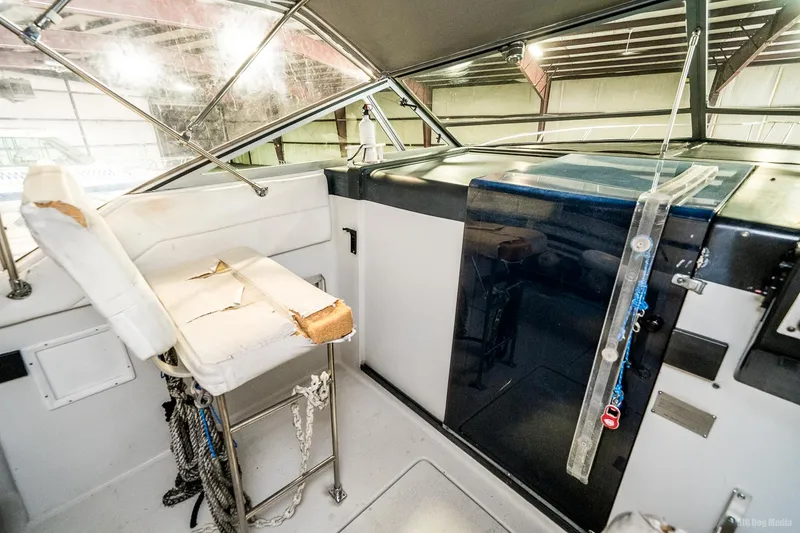 Slide: The Image of 1987 Chris-Craft 320 Amerosport Express boat interior with worn captain's seat. - 25